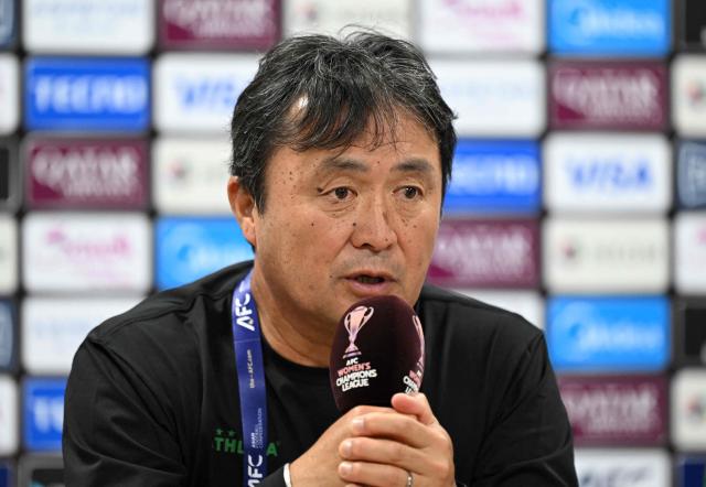 Japan's Tokyo Verdy Beleza head coach Naoki Kusunose (L) speaks during a press conference at Suwon Sports Complex in Suwon on May 22, 2026, ahead of the AFC Women's Champions League final football match. (Photo by Jung Yeon-je / AFP)