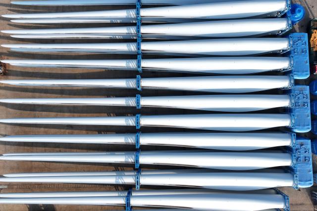 Wind turbine blades made by Vensys are seen on a dock as they are prepared for export at the port in Lianyungang, in China’s eastern Jiangsu province on May 22, 2026. (Photo by CN-STR / AFP) / China OUT
