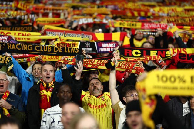 (FILES) Lens' supporters cheer their team during the French Cup semi-final football match between and RC Lens and Toulouse FC at the Stade Bollaert-Delelis in Lens, northern France on April 21, 2026. Fervour around RC Lens is building in the Pas-de-Calais mining basin ahead of the French Cup final on May 22, 2026 against Nice, with hopes of lifting this trophy for the first time at the end of a brilliant season. (Photo by Sameer AL-DOUMY / AFP)