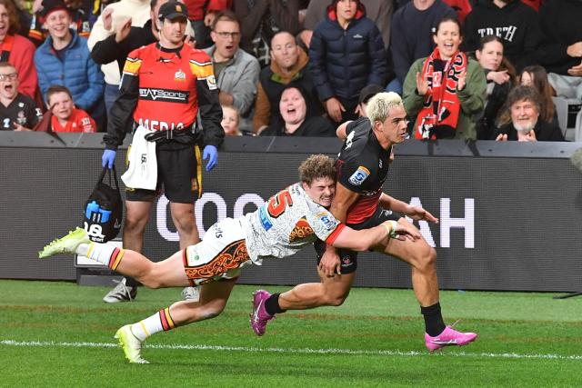 Crusaders' Noah Hotham (R) is tackled by Chiefs' Isaac Hutchinson during the Super Rugby Pacific match between the Crusaders and Chiefs at One New Zealand Stadium in Christchurch on May 22, 2026. (Photo by Sanka Vidanagama / AFP)