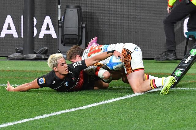 Crusaders' Noah Hotham (L) scores a try during the Super Rugby Pacific match between the Crusaders and Chiefs at One New Zealand Stadium in Christchurch on May 22, 2026. (Photo by Sanka Vidanagama / AFP)