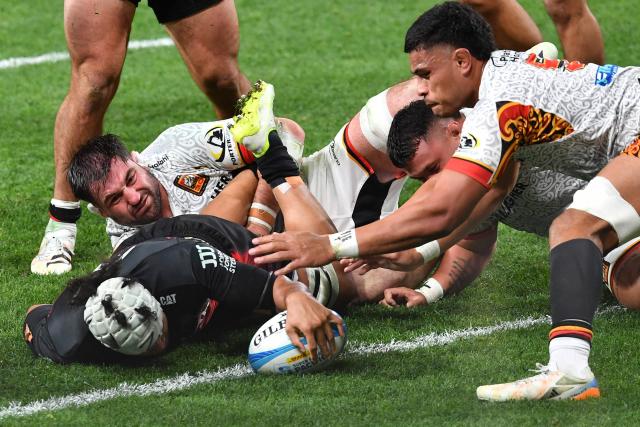 Crusaders' Leicester Fainga’anuku (L) scores a try during the Super Rugby Pacific match between the Crusaders and Chiefs at One New Zealand Stadium in Christchurch on May 22, 2026. (Photo by Sanka Vidanagama / AFP)