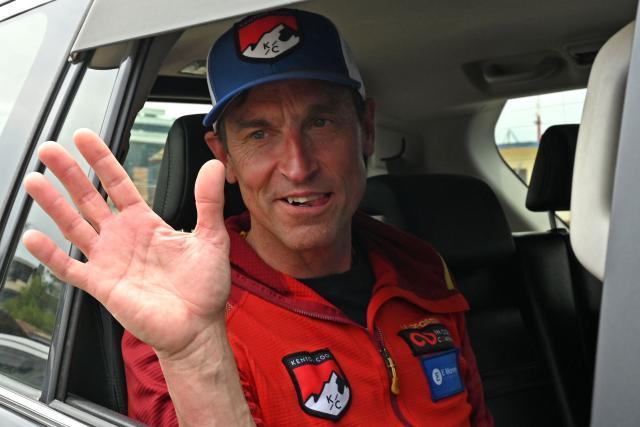 (FILES) British climber Kenton Cool waves from a car upon his arrival at the airport in Kathmandu on May 20, 2025. British climber Kenton Cool reached the top of Mount Everest for the 20th time on May 22, 2026 extending his own record for the most ascents of the world's highest peak by a non-Nepali. (Photo by Prakash MATHEMA / AFP)