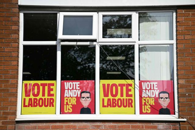 Posters supporting the Labour Party and Greater Manchester Mayor Andy Burnham are pictured in a window ahead of an event to launch Burnham's by-election campaign in Ashton-in-Makerfield, west of Manchester in north-west England on May 22, 2026. The Makerfield by-election, expected in mid-June at the earliest, may see Burnham return to the government though he would face a tough fight from the poll-topping Reform UK. (Photo by Paul ELLIS / AFP)
