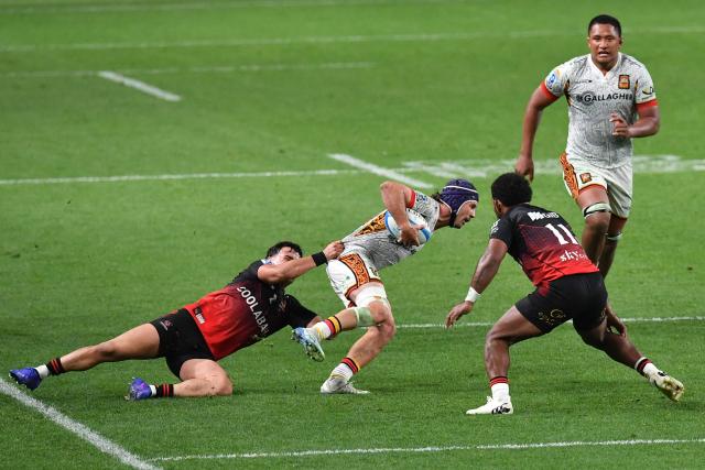 Chiefs' Liam Coombes-Fabling (C) is tackled during the Super Rugby Pacific match between the Canterbury Crusaders and Waikato Chiefs at One New Zealand Stadium in Christchurch on May 22, 2026. (Photo by Sanka Vidanagama / AFP)