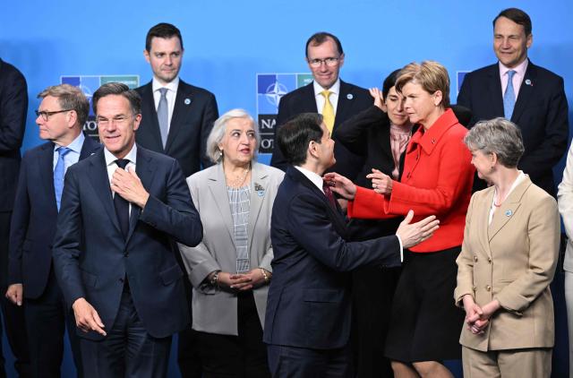 NATO Secretary General Mark Rutte (L) looks on as US Secretary of State Marco Rubio (C) greets Latvia's Foreign Minister Baiba Braze (red jacket, R) as they prepare to pose for a family photo at the NATO Foreign Ministers' meeting in Helsingborg, Sweden, on May 22, 2026. Foreign ministers of the 32 NATO member states gathered in the Swedish city to finalise preparations for the upcoming Ankara Summit. (Photo by Jonathan Nackstrand / AFP)