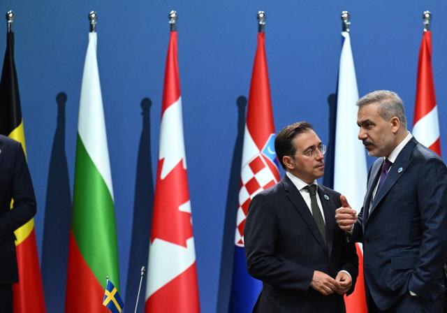 Turkish Foreign Minister Hakan Fidan (R) talks with Spain's Foreign Minister Jose Manuel Albares Bueno at the NATO Foreign Ministers' meeting in Helsingborg, Sweden, on May 22, 2026. Foreign ministers of the 32 NATO member states gathered in the Swedish city to finalise preparations for the upcoming Ankara Summit. (Photo by Jonathan Nackstrand / AFP)