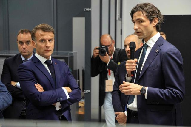 France's President Emmanuel Macron (2nd L) listens to CEO of Quandela Niccolo Somaschi (R) 
flanked by France's Prime Minister Sebastien Lecornu (L) during the presentation of a Quandela photonic quantum computer as part of a visit to the European Forum on Computing Power, Quantum Sciences and Technologies, and Semiconductors at the Very Large Computing Centre of the French Alternative Energies and Atomic Energy Commission (CEA) in Bruyeres-le-Chatel, south of Paris on May 22, 2026. (Photo by Ludovic MARIN / POOL / AFP)