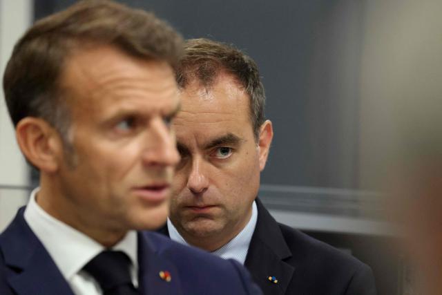France's Prime Minister Sebastien Lecornu (R) looks on as France's President Emmanuel Macron listens during a visit to the European Forum on Computing Power, Quantum Sciences and Technologies, and Semiconductors at the Very Large Computing Centre of the French Alternative Energies and Atomic Energy Commission (CEA) in Bruyeres-le-Chatel, south of Paris on May 22, 2026. (Photo by Ludovic MARIN / POOL / AFP)
