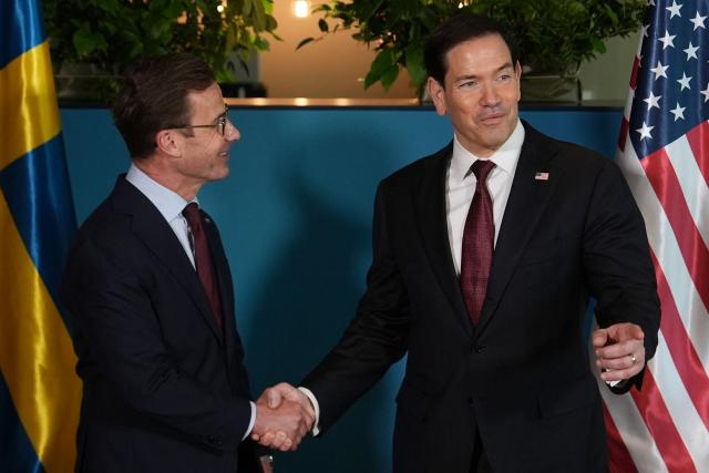US Secretary of State Marco Rubio (R)  shakes hands with Sweden's Prime Minister Ulf Kristersson on the sidelines of the NATO Foreign Ministers' meeting in Helsingborg, Sweden, on May 22, 2026. Foreign ministers of the 32 NATO member states gathered in the Swedish city to finalise preparations for the upcoming Ankara Summit. (Photo by Julia Demaree Nikhinson / POOL / AFP)