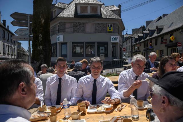 General Secretary of French centrist party Renaissance Gabriel Attal (C) has lunch with members of his team and supporters after announcing his candidacy for the 2027 presidential elections during a visit to the village of Mur-de-Barrez in the Aveyron department, southwestern France on May 22, 2026. France's former prime minister Gabriel Attal said on May 22, 2026 he was running for president next year, becoming the second prominent centrist to challenge the far right when Emmanuel Macron steps down. (Photo by Ed JONES / AFP)