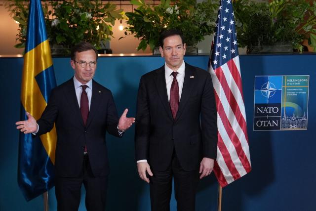 US Secretary of State Marco Rubio (R) poses with Sweden's Prime Minister Ulf Kristersson on the sidelines of the NATO Foreign Ministers' meeting in Helsingborg, Sweden, on May 22, 2026. Foreign ministers of the 32 NATO member states gathered in the Swedish city to finalise preparations for the upcoming Ankara Summit. (Photo by Julia Demaree Nikhinson / POOL / AFP)