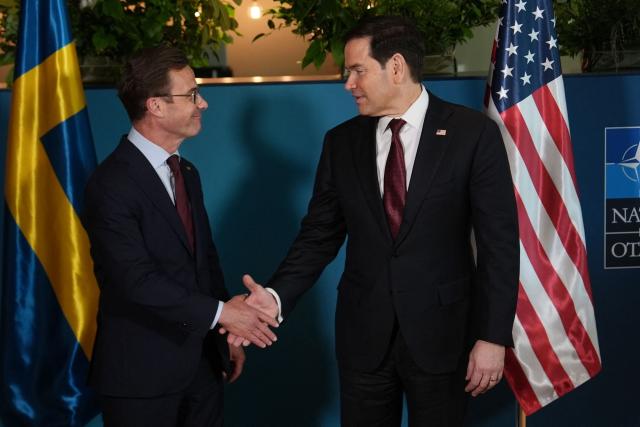 US Secretary of State Marco Rubio (R)  shakes hands with Sweden's Prime Minister Ulf Kristersson on the sidelines of the NATO Foreign Ministers' meeting in Helsingborg, Sweden, on May 22, 2026. Foreign ministers of the 32 NATO member states gathered in the Swedish city to finalise preparations for the upcoming Ankara Summit. (Photo by Julia Demaree Nikhinson / POOL / AFP)