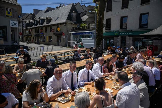 General Secretary of French centrist party Renaissance Gabriel Attal (C) has lunch with members of his team and supporters after announcing his candidacy for the 2027 presidential elections during a visit to the village of Mur-de-Barrez in the Aveyron department, southwestern France on May 22, 2026. France's former prime minister Gabriel Attal said on May 22, 2026 he was running for president next year, becoming the second prominent centrist to challenge the far right when Emmanuel Macron steps down. (Photo by Ed JONES / AFP)