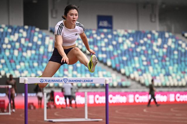 China's Wu Yanni trains one day ahead of the Diamond League Xiamen athletics meeting at Egret Stadium in Xiamen, in China’s eastern Fujian province on May 22, 2026. (Photo by Jade GAO / AFP)