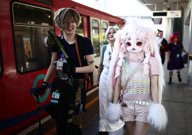 Cosplayers leave the train as they arrive for the MCM Comic Con at ExCeL exhibition centre in London on May 22, 2026. (Photo by Henry NICHOLLS / AFP)