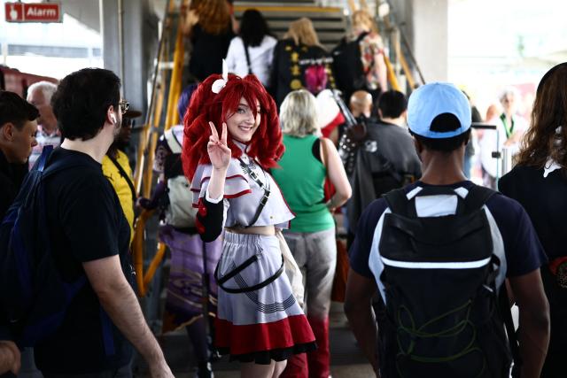 Cosplayers leave the platform after arriving by train, as they arrive for the MCM Comic Con at ExCeL exhibition centre in London on May 22, 2026. (Photo by Henry NICHOLLS / AFP)