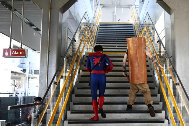 Cosplayers leave the platform after arriving by train, as they arrive for the MCM Comic Con at ExCeL exhibition centre in London on May 22, 2026. (Photo by Henry NICHOLLS / AFP)