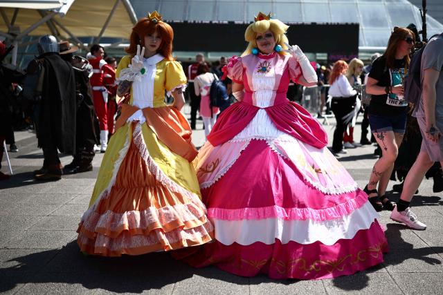 Cosplayers pose for a photo as they arrive for the MCM Comic Con at ExCeL exhibition centre in London on May 22, 2026. (Photo by Henry NICHOLLS / AFP)