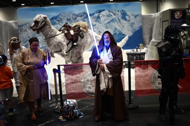 A cosplayer dressed as Obi-Wan Kenobi from Star Wars poses for a photo during the MCM Comic Con at ExCeL exhibition centre in London on May 22, 2026. (Photo by Henry NICHOLLS / AFP)