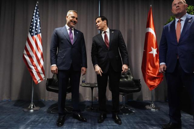 United States Secretary of State Marco Rubio (C) stands next to Turkish Foreign Minister Hakan Fidan (L) as they meet on the sidelines of the NATO Foreign Ministers' meeting in Helsingborg, Sweden, on May 22, 2026. Foreign ministers of the 32 NATO member states gathered in the Swedish city to finalise preparations for the upcoming Ankara Summit. (Photo by Julia Demaree Nikhinson / POOL / AFP)