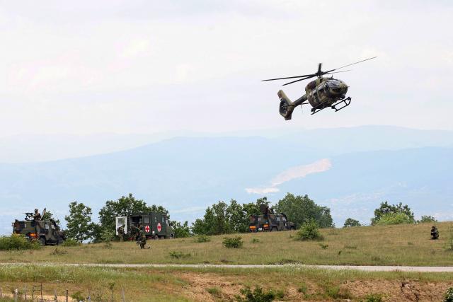 Soldiers navigate an Airbus H145M military light utility "Caracal" helicopter as they take part in the joint "NATO–Serbia" military exercise at a training ground near Bujanovac in southern Serbia on May 22, 2026, during the first military drills conducted directly between Serbia and NATO. Around 600 troops from Serbia, Italy, Romania and Turkey participated in the exercise under NATO’s Partnership for Peace programme, which Belgrade says respects the country’s policy of military neutrality. The drills mark a rare public military cooperation between Serbia and the Alliance, whose 1999 bombing campaign during the Kosovo war remains a sensitive subject in the Balkan country. (Photo by Sasa Djordjevic / AFP)