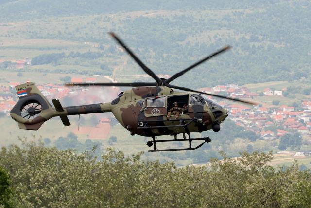 Soldiers navigate an Airbus H145M military light utility "Caracal" helicopter as they take part in the joint "NATO–Serbia" military exercise at a training ground near Bujanovac in southern Serbia on May 22, 2026, during the first military drills conducted directly between Serbia and NATO. Around 600 troops from Serbia, Italy, Romania and Turkey participated in the exercise under NATO’s Partnership for Peace programme, which Belgrade says respects the country’s policy of military neutrality. The drills mark a rare public military cooperation between Serbia and the Alliance, whose 1999 bombing campaign during the Kosovo war remains a sensitive subject in the Balkan country. (Photo by Sasa Djordjevic / AFP)