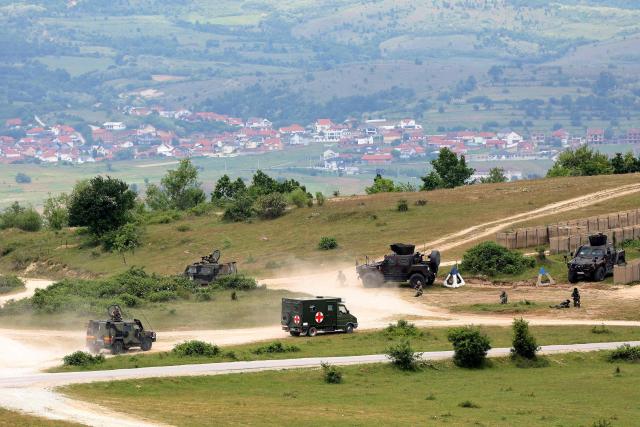 Soldiers take part in the joint "NATO–Serbia" military exercise at a training ground near Bujanovac in southern Serbia on May 22, 2026, during the first military drills conducted directly between Serbia and NATO. Around 600 troops from Serbia, Italy, Romania and Turkey participated in the exercise under NATO’s Partnership for Peace programme, which Belgrade says respects the country’s policy of military neutrality. The drills mark a rare public military cooperation between Serbia and the Alliance, whose 1999 bombing campaign during the Kosovo war remains a sensitive subject in the Balkan country. (Photo by Sasa Djordjevic / AFP)