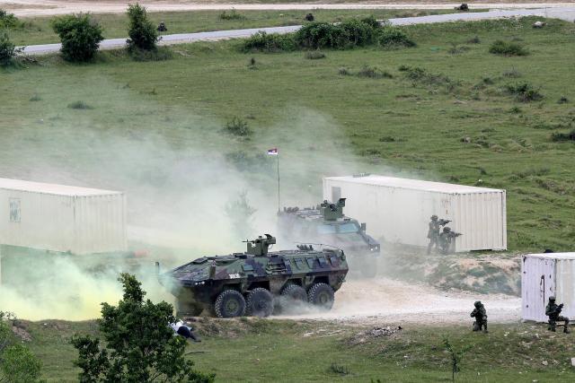 Soldiers navigate Lazar 3M armoured personnel carrier military vehicles as they take part in the joint "NATO–Serbia" military exercise at a training ground near Bujanovac in southern Serbia on May 22, 2026, during the first military drills conducted directly between Serbia and NATO. Around 600 troops from Serbia, Italy, Romania and Turkey participated in the exercise under NATO’s Partnership for Peace programme, which Belgrade says respects the country’s policy of military neutrality. The drills mark a rare public military cooperation between Serbia and the Alliance, whose 1999 bombing campaign during the Kosovo war remains a sensitive subject in the Balkan country. (Photo by Sasa Djordjevic / AFP)