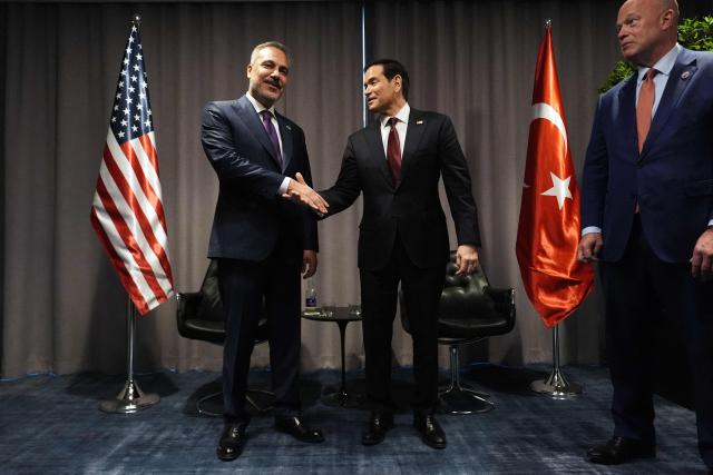 United States Secretary of State Marco Rubio (C) shakes hands with Turkish Foreign Minister Hakan Fidan (L) as they meet on the sidelines of the NATO Foreign Ministers' meeting in Helsingborg, Sweden, on May 22, 2026. Foreign ministers of the 32 NATO member states gathered in the Swedish city to finalise preparations for the upcoming Ankara Summit. (Photo by Julia Demaree Nikhinson / POOL / AFP)
