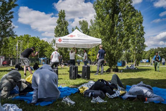Red Cross staff set up tents intended as shelter from the sun outside an overcrowded asylum seekers' registration centre in Ter Apel, northern Netherlands on May 22, 2026. (Photo by Jilmer Postma / ANP / AFP) / Netherlands OUT