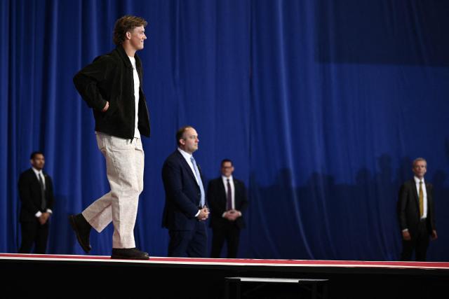 New York Giants quarterback Jaxson Dart walks on the stage to introduce US President Donald Trump to the crowd before Trump's speech about the economy at Rockland Community College Fieldhouse in Suffern, New York, on May 22, 2026. Trump is the first sitting president to visit the northern New York City suburbs since Gerald Ford in 1976. (Photo by Brendan SMIALOWSKI / AFP)
