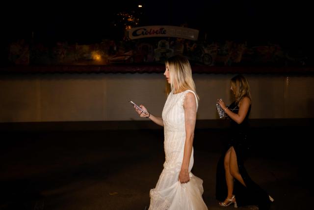 Festival-goers walk on the Boulevard de la Croisette during the 79th edition of the Cannes Film Festival in Cannes, southern France, on May 22, 2026. (Photo by Anna KURTH / AFP)