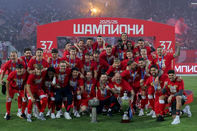 FK Crvena Zvezda (Red Star) players celebrate their Serbian SuperLiga and Serbian Cup trophies at the Rajko Mitic Stadium in Belgrade on May 22, 2026, before their SuperLiga match against OFK Belgrade. (Photo by Pedja Milosavljevic / AFP)