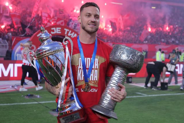 FK Crvena Zvezda (Red Star) Austrian player Marko Arnautovic celebrates with the Serbian SuperLiga and Serbian Cup trophies at the Rajko Mitic Stadium in Belgrade on May 22, 2026, before their SuperLiga match against OFK Belgrade. (Photo by Pedja Milosavljevic / AFP)