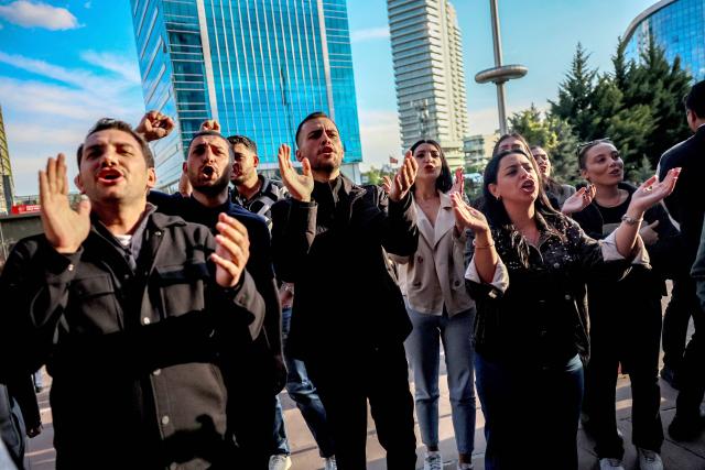 Demonstrators chant slogans as leader of Republican People's Party (CHP) Ozgur Ozel arrives at the party headquarters during a protest against allegations of vote buying at the CHP congress in November 2023, in Ankara, on May 22, 2026. An Ankara court on May 21, 2026 annulled the 2023 leadership election of Turkey's main opposition CHP party, state news agency Anadolu reported, in a sharp escalation against the country's embattled opposition. The ruling overturns the result of the leadership election that brought in current party head Ozgur Ozel -- and ordered that the party's former longterm chair, Kemal Kilicdaroglu -- who lost the election to Ozel -- take over as interim leader. (Photo by Adem ALTAN / AFP)