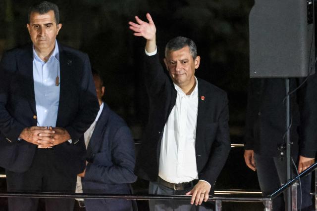 Leader of Republican People's Party (CHP) Ozgur Ozel waves to supporters during a protest against allegations of vote buying at the CHP congress in November 2023, at the party headquarters in Ankara on May 22, 2026. An Ankara court on May 21 annulled the 2023 leadership election of Turkey's main opposition CHP party, state news agency Anadolu reported, in a sharp escalation against the country's embattled opposition. The ruling overturns the result of the leadership election that brought in current party head Ozgur Ozel -- and ordered that the party's former longterm chair, Kemal Kilicdaroglu -- who lost the election to Ozel -- take over as interim leader. (Photo by ADEM ALTAN / AFP)
