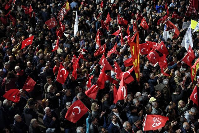 Supporters wave Turkish national flags as the leader of Republican People's Party (CHP) delivers a speech during a protest against allegations of vote buying at the CHP congress in November 2023, at their party headquarters in Ankara on May 22, 2026. An Ankara court on May 21 annulled the 2023 leadership election of Turkey's main opposition CHP party, state news agency Anadolu reported, in a sharp escalation against the country's embattled opposition. The ruling overturns the result of the leadership election that brought in current party head Ozgur Ozel -- and ordered that the party's former longterm chair, Kemal Kilicdaroglu -- who lost the election to Ozel -- take over as interim leader. (Photo by ADEM ALTAN / AFP)