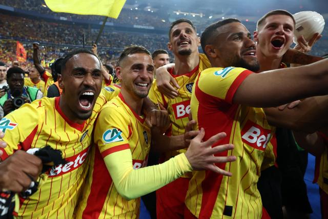 Lens' players including Lens' French forward #22 Wesley Said (L), Lens' French defender #02 Ruben Aguilar, Lens' French forward #07 Florian Sotoca, Lens' French defender #14 Matthieu Udol and Lens' Bosnian defender #04 Nidal Celik celebrate winning at the end of the French Cup final football match between RC Lens and OGC Nice at the Stade de France stadium, in Saint-Denis, on the outskirts of Paris, on May 22, 2026. (Photo by FRANCK FIFE / AFP)