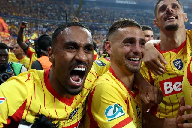Lens' players including Lens' French forward #22 Wesley Said (L), Lens' French defender #02 Ruben Aguilar and Lens' French forward #07 Florian Sotoca celebrate winning at the end of the French Cup final football match between RC Lens and OGC Nice at the Stade de France stadium, in Saint-Denis, on the outskirts of Paris, on May 22, 2026. (Photo by FRANCK FIFE / AFP)