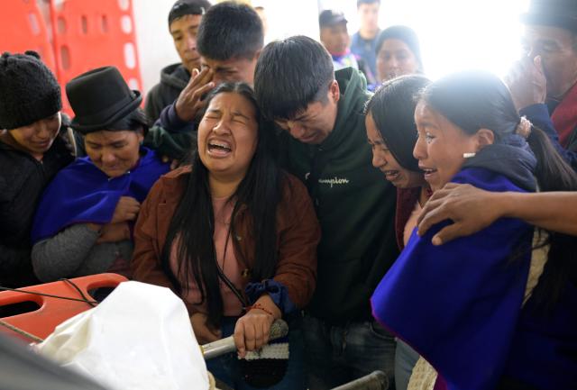 Misak indigenous mourn next to the body of the indigenous leader Luis Enrique Tunubala at the Guambia reserve near Silvia, Cauca department, Colombia on May 22, 2026. A land dispute between two indigenous groups left six people dead and 65 injured in a troubled region of Colombia on May 22, 2026, according to local authorities. (Photo by Joaquin SARMIENTO / AFP)