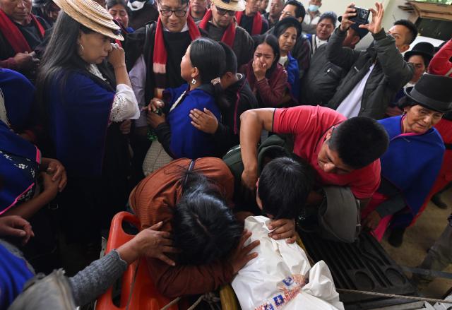 Misak indigenous mourn next to the body of the indigenous leader Luis Enrique Tunubala at the Guambia reserve near Silvia, Cauca department, Colombia on May 22, 2026. A land dispute between two indigenous groups left six people dead and 65 injured in a troubled region of Colombia on May 22, 2026, according to local authorities. (Photo by JOAQUIN SARMIENTO / AFP)
