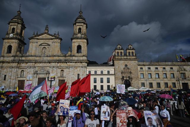 Supporters hold placards depicting his image of Colombia's presidential candidate Ivan Cepeda for the Pacto Historico party ahead of the start of a campaign rally at Plaza Bolivar in Bogota on May 22, 2026. Colombia will hold presidential elections on May 31. (Photo by Raul ARBOLEDA / AFP)