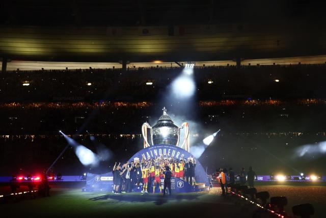 Lens' players celebrate with the trophy after winning the French Cup final football match between RC Lens and OGC Nice at the Stade de France stadium, in Saint-Denis, on the outskirts of Paris, on May 22, 2026. (Photo by FRANCK FIFE / AFP)