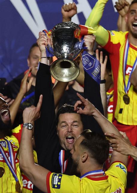 Lens' team including Lens' French head coach Pierre Sage (C) brandishing the trophy celebrate after winning the French Cup final football match between RC Lens and OGC Nice at the Stade de France stadium, in Saint-Denis, on the outskirts of Paris, on May 22, 2026. (Photo by FRANCK FIFE / AFP)