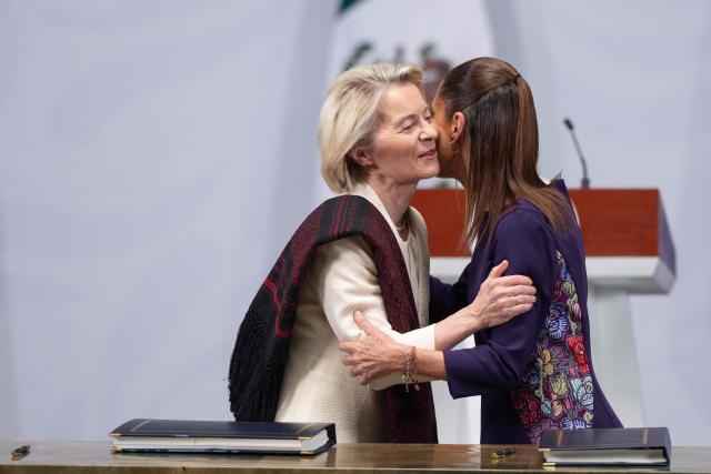 Mexico's President Claudia Sheinbaum (R) and European Commission President Ursula von der Leyen embrace each other after the signing of agreements during a press conference at the National Palace in Mexico City on May 22, 2026. The European Union and Mexico will sign a deal on May 22 to reduce tariffs on each other's goods, as both seek to lessen their dependence on trade with the United States. (Photo by Gerardo Luna / AFP)