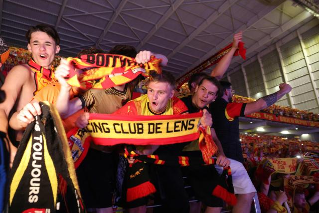 Lens RC supporters celebrate winning the French Cup final against Nice OGC after wathing the game on a giant screen at the Bollaert stadium in Lens, northern France, on May 22, 2026. (Photo by Francois LO PRESTI / AFP)