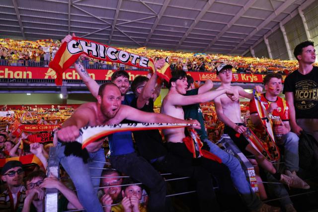 Lens RC supporters celebrate winning the French Cup final against Nice OGC after wathing the game on a giant screen at the Bollaert stadium in Lens, northern France, on May 22, 2026. (Photo by Francois LO PRESTI / AFP)