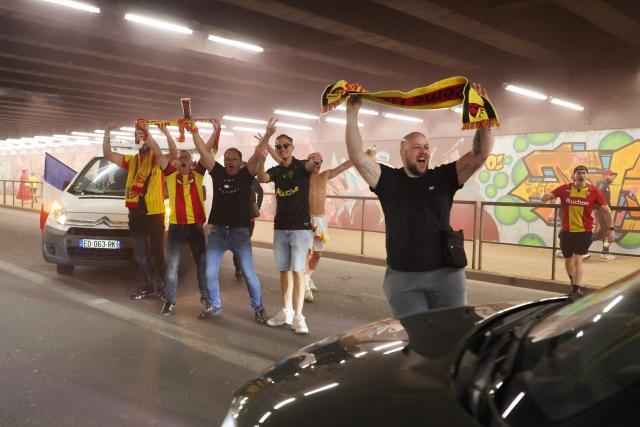 RC Lens supporters celebrate in the streets after their team’s victory over OGC Nice in the French Cup final, in Lens, northern France, on May 22, 2026. (Photo by Francois LO PRESTI / AFP)