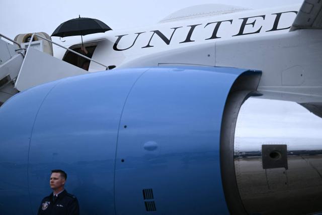 An umbrella is held aloft before the US president steps off of Air Force One upon arrival at Joint Base Andrews in Maryland on May 22, 2026. Trump is returning to the White House after delivering remarks in New York. (Photo by Brendan SMIALOWSKI / AFP)